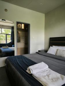 a bedroom with a bed with two towels on it at Grapes Garden Resort Hunza in Hunza Valley