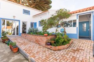 a house with a brick walkway in front of it at Casa da Annelies. Accessible holiday home in Nadadouro