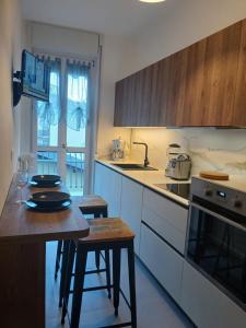 a kitchen with a table and a counter top at OASI appartamento in Cannobio