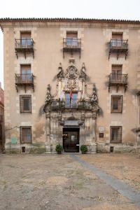 an old building with a flag in front of it at Hospederia Seminario Conciliar de San Julián in Cuenca