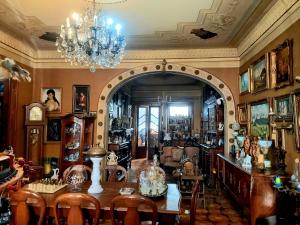 a room with a table and chairs and a chandelier at Kutaisi Family Museum in Kutaisi