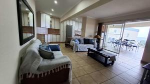 a living room with a couch and a table at 7 Uvongo Breeze in Margate