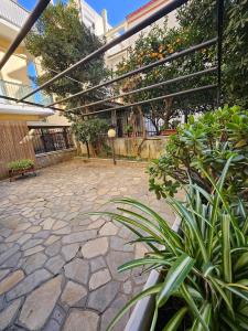 a patio with some plants on a stone ground at Residence Rodi in Alassio +33 photos
