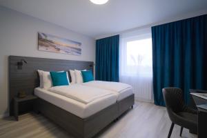 Postel nebo postele na pokoji v ubytování Hotel Kiel by MELIO