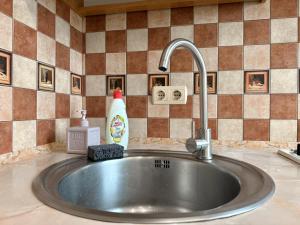 a sink in a kitchen with a faucet at ApartPoltava Стильна квартира біля Білої Альтанки, серце Полтави in Poltava