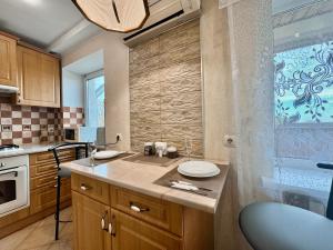 a kitchen with a counter with a sink in it at ApartPoltava Стильна квартира біля Білої Альтанки, серце Полтави in Poltava