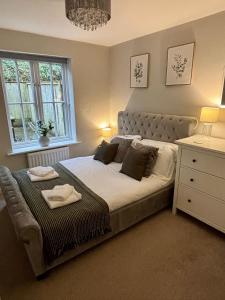 a bedroom with a large bed and a window at Stylish & spacious harbour-view townhouse with parking in Whitby