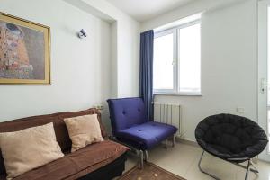a living room with a couch and a blue chair at 1BR Apartment in Gudauri in Gudauri