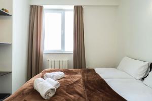 a bedroom with a bed with towels on it at 1BR Apartment in Gudauri in Gudauri