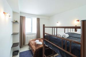 a bedroom with a bunk bed and a window at 1BR Apartment in Gudauri in Gudauri +16 photos