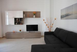 a living room with a couch and a flat screen tv at Sesto Piano House in Monopoli