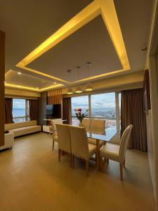a dining room with a table and chairs with a view at Avida Towers Condo Near Peoples Park and Roxas Night Market in Davao City