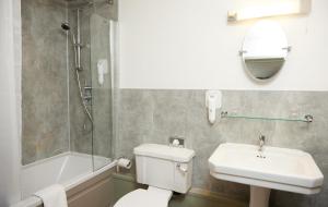 a bathroom with a toilet and a sink and a shower at Castle Inn by Greene King Inns in Bakewell +17 photos