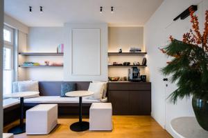 a living room with a couch and a table at Istoire in Bruges