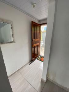 an empty room with a door and a mirror at Casa Simples 2 Quartos Privada in Paraty +13 photos