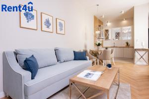 a living room with a couch and a table at Nad Zatoką Aparthotel by Rent4You in Olsztyn +61 photos