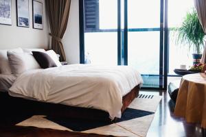 a bedroom with a large bed with a large window at Luxury Apartment in Hai Phong near CatBi international Aport in Ðông Khê +12 photos
