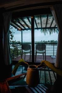 a view of a porch with two chairs and a table at Kadal boutique beach stay in Green Island