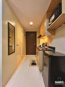 a small kitchen with a counter and a hallway at Condo near Session Road with City View in Baguio