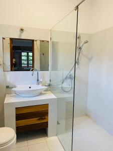 a bathroom with a sink and a shower at Sagarika Beach Hotel in Moragalla +128 photos