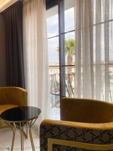 a room with a large window with a table and chairs at Park Milano Hotel in İzmir +14 photos
