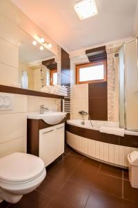 a bathroom with a toilet and a sink and a tub at U Pabinów in Kościelisko +147 photos