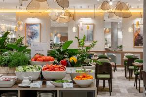 a store with bowls of vegetables on a table at Wyndham Wroclaw Old Town in Wrocław