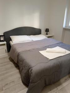 a bed with two white towels on top of it at Venezuela in Milan