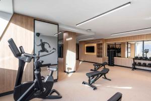 a gym with treadmills and exercise bikes in a room at Wyndham Wroclaw Old Town in Wrocław