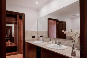 a bathroom with two sinks and a large mirror at Es Puig De Portocolom in Cala Murada +22 photos
