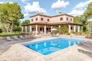 an estate with a swimming pool in front of a house at Es Puig De Portocolom in Cala Murada