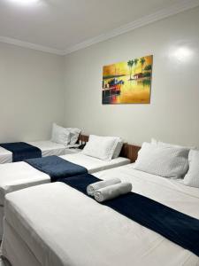 a group of three beds in a room at Nautillus Hotel in Parnaíba +83 photos