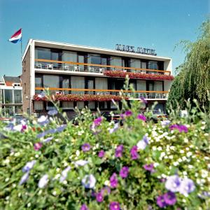 un bâtiment d'hôtel avec des fleurs devant lui dans l'établissement Marx Motel, à Fauquemont
