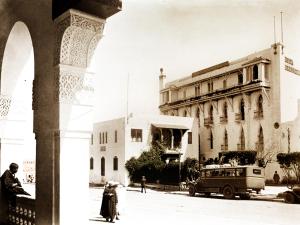 a man walking down a street next to a building at Hotel des Oudaias in Rabat