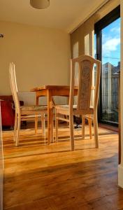 a wooden table and chairs in a living room at cosy beautiful room in Lancaster