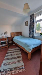 a bedroom with a large bed with a blue sheet at cosy beautiful room in Lancaster
