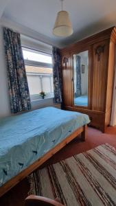 a bedroom with a bed and a large mirror at cosy beautiful room in Lancaster