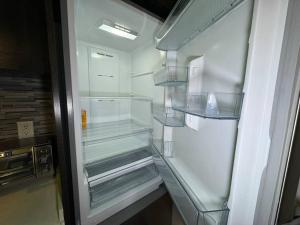 an empty refrigerator with its door open in a kitchen at Modern condo near Fremont Street in Las Vegas +236 photos