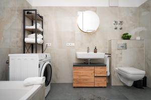 a bathroom with a sink and a washing machine at KeyHosting Apartment Zentral Parkplatz in Aschaffenburg