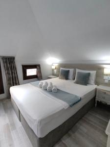 A bed or beds in a room at Green House Skiathos