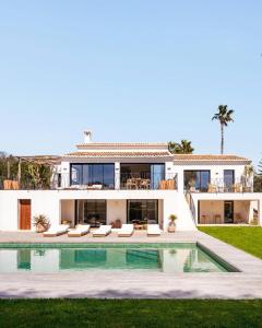 a villa with a swimming pool and a house at Villa Jade in Jávea