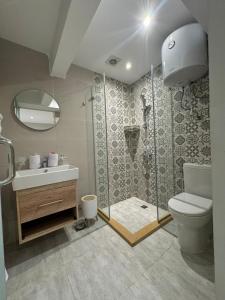a bathroom with a shower and a toilet and a sink at Khufu Pyramids View Inn in Cairo