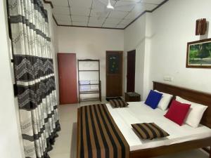 a bedroom with a bed with two pillows at Coastal Heaven in Bentota