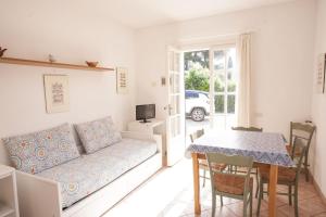 a living room with a couch and a table at Appartamenti Villa Anna - Goelba in Capoliveri