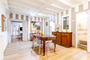 a dining room with a wooden table and chairs at Elegantis Monti Suite Apartment in Rome