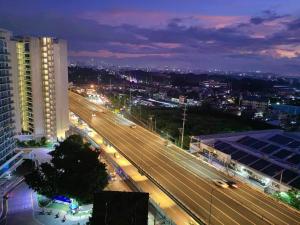 a view of a city at night with traffic at Skyrest Staycation - Azure Urban Resort in Manila +5 photos