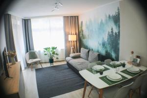 a living room with a couch and a table at Schönhier - Design Apartment mit Pool, Sauna in Schluchsee +24 photos