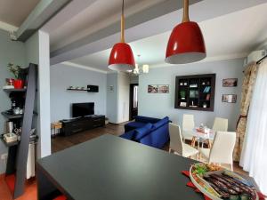 a living room with a table and a blue couch at SGB Apartment in Timişoara