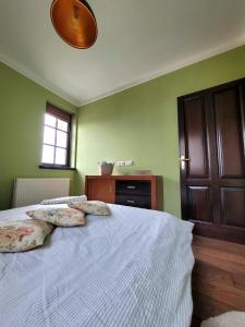 a bedroom with a bed with two pillows on it at SGB Apartment in Timişoara