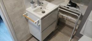 a bathroom with a white sink and a toilet at L'HIBISCUS de l'Audière in Malaunay +57 photos